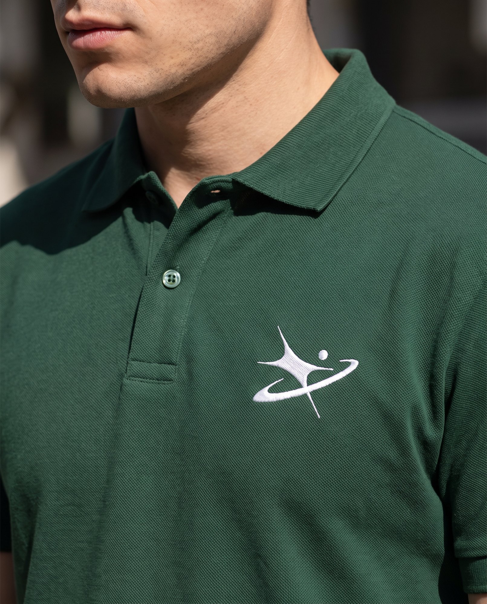Embroidered symbol on a green polo